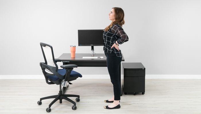 Person demonstrating a gentle stretching exercise suitable for office environment